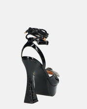 JANINE - tacchi alti con platform in glassy nero e fiocco con gemme