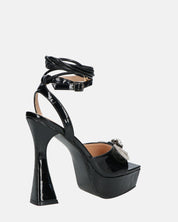 JANINE - tacchi alti con platform in glassy nero e fiocco con gemme